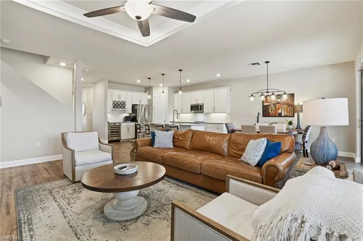 Living room with recessed lighting, light wood-style flooring, a ceiling fan, and wine cooler