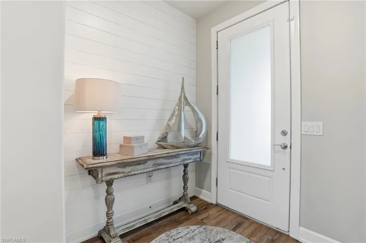 Foyer entrance featuring wood finished floors and baseboards