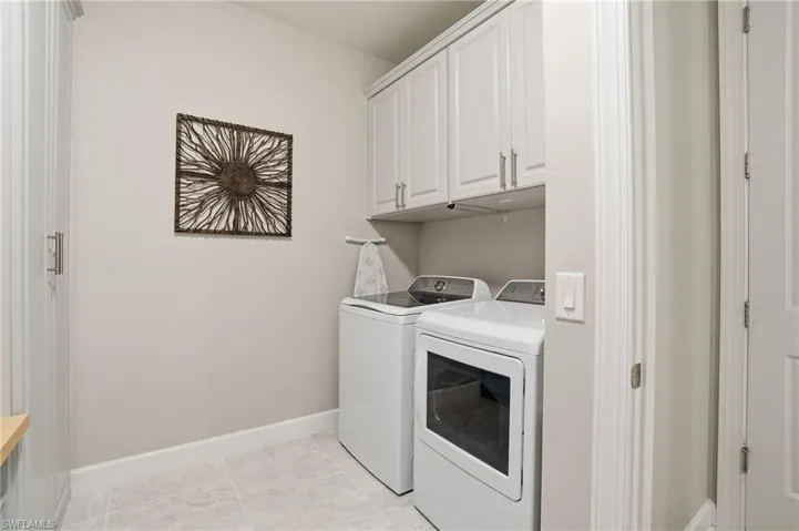 Laundry room featuring cabinet space and washer and dryer