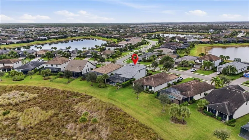 Aerial view of residential area featuring a nearby body of water