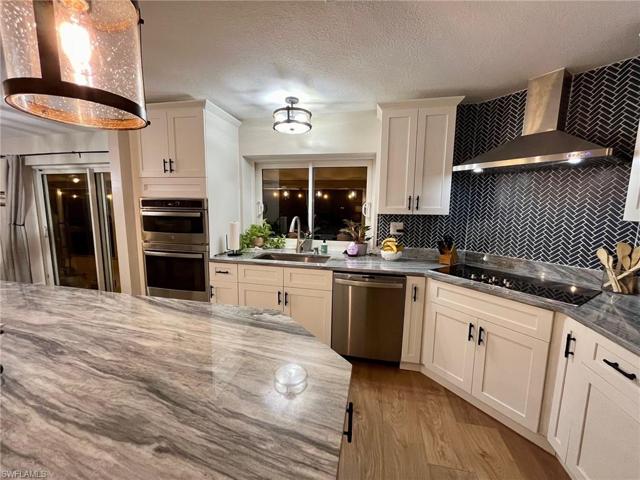 White Shaker cabinets, Marble countertops, tile back splash all new GE Profile Stainless Steel Appliances. 5 Burner electric cook top, power in island