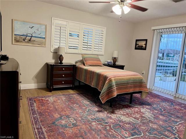 Guest Bed 2 with Imapact Sliding glass doors to Patio and view of canal
