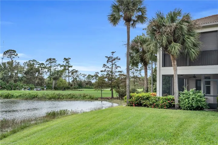 View of yard featuring a water view and ceiling fan