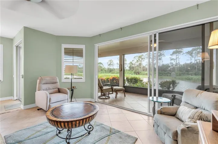 Sunroom / solarium with a water view and ceiling fan
