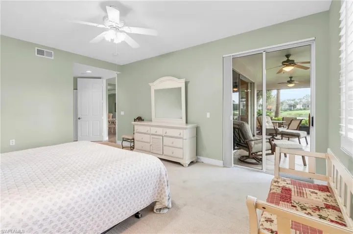 Bedroom featuring a closet, light carpet, and ceiling fan