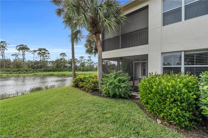 View of yard featuring a water view and a sunroom