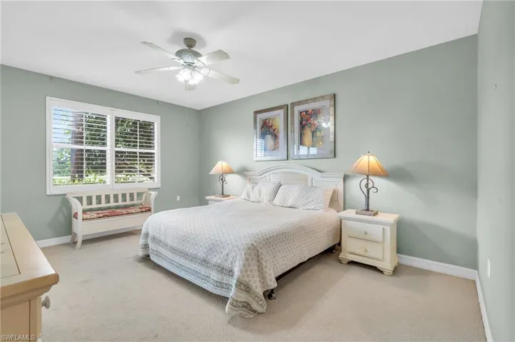 Carpeted bedroom with ceiling fan