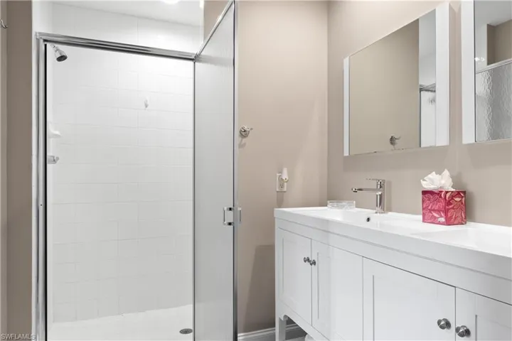 Bathroom featuring vanity and an enclosed shower