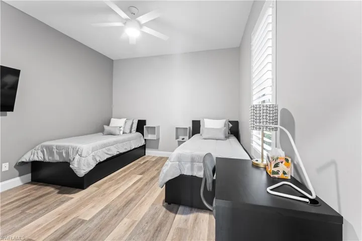 Bedroom with ceiling fan and wood-type flooring