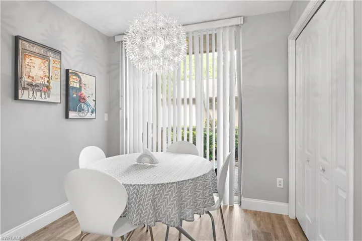 Dining area featuring hardwood / wood-style floors and an inviting chandelier