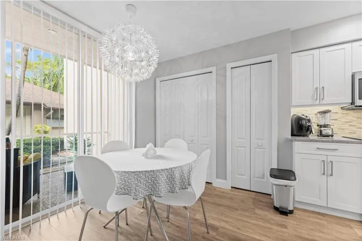 Dining area with light hardwood / wood-style flooring and a chandelier