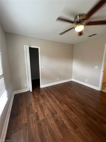 Laundry area with light tile patterned floors and heating unit