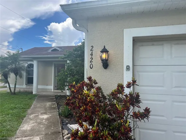 Entrance to property featuring stucco siding and a garage