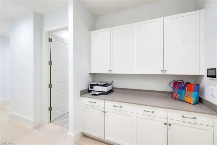 Kitchen featuring white cabinetry and baseboards