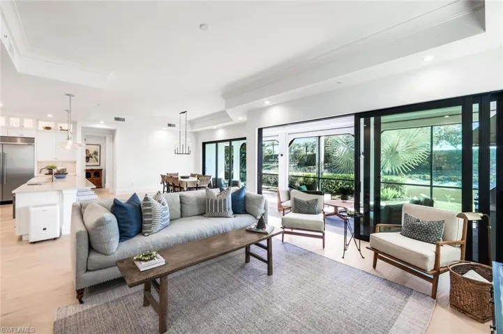 Living room featuring light wood-style floors, recessed lighting, and ornamental molding