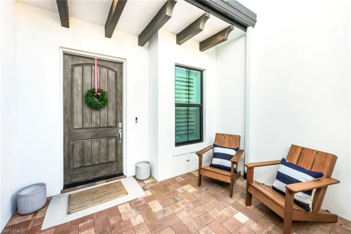 View of exterior entry with stucco siding