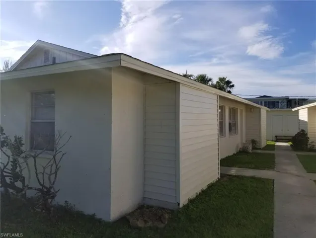 View of side of property featuring a shed