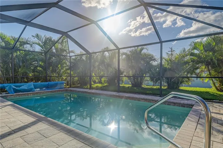 View of swimming pool with a lanai