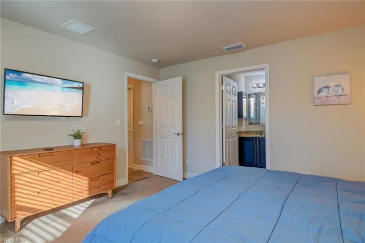 Carpeted bedroom with ensuite bath