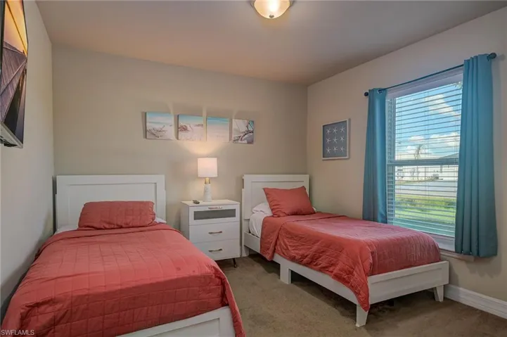 Carpeted bedroom with multiple windows