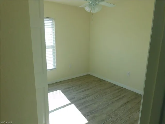 Empty room featuring wood finished floors and baseboards