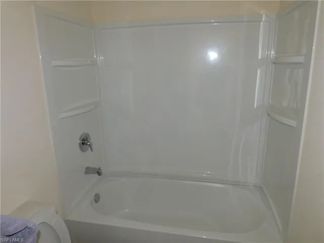 Full bathroom featuring bathtub / shower combination and toilet