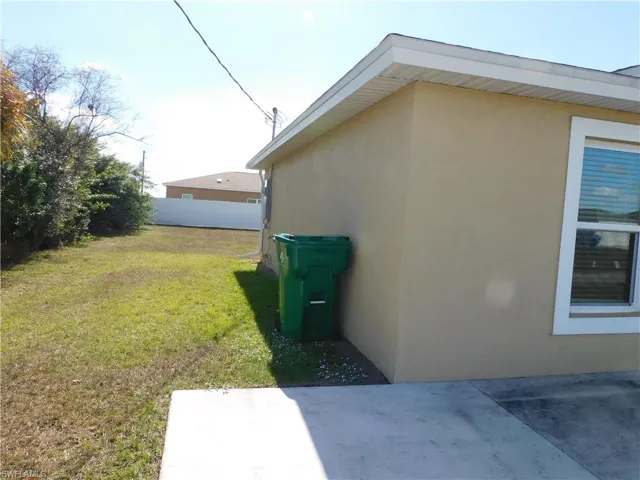 View of side of home featuring stucco siding