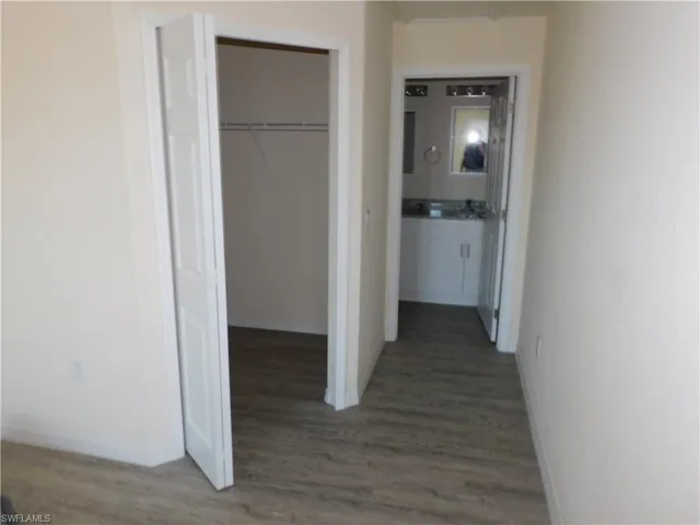Hallway with wood finished floors and baseboards