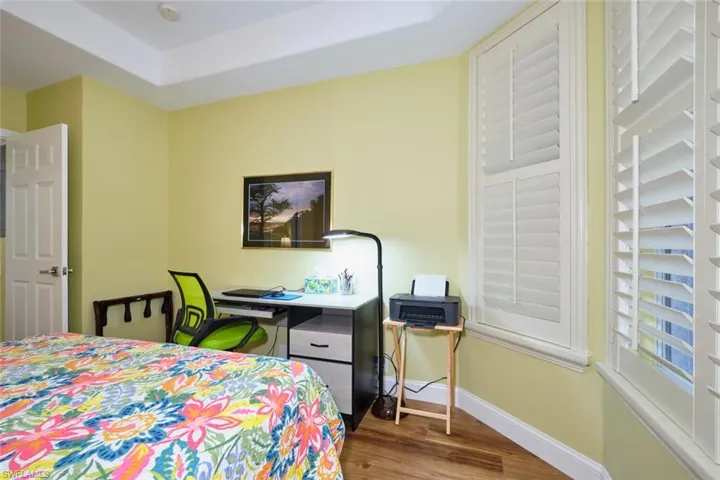 Bedroom featuring baseboards and wood finished floors