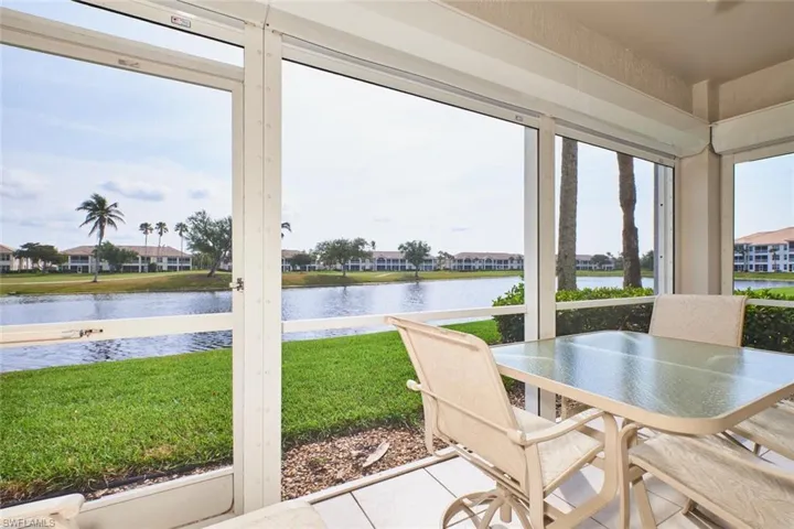 Sunroom with a water view and tile patterned floors