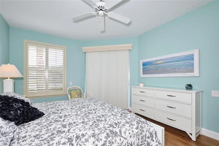 Bedroom featuring baseboards, ceiling fan, and wood finished floors