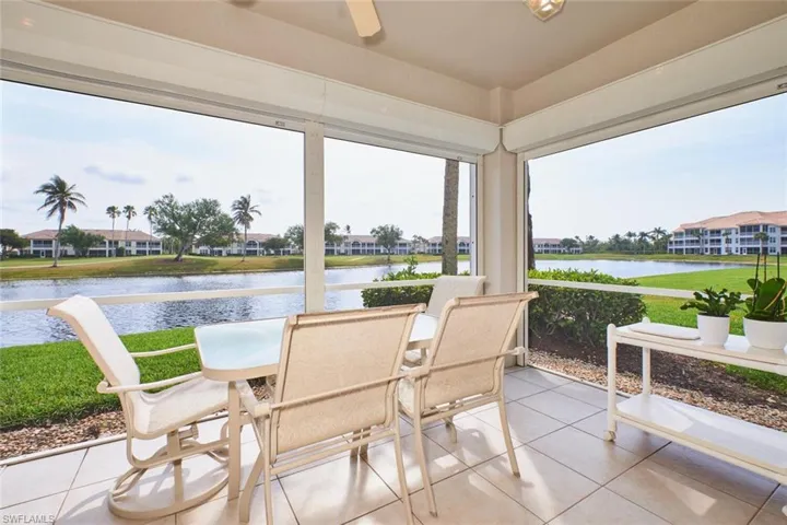 Sunroom featuring a water view and tile patterned flooring