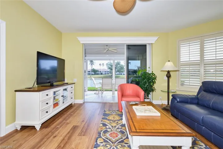 Living room with wood finished floors, baseboards, and ceiling fan