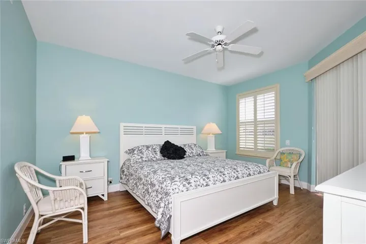 Bedroom featuring a ceiling fan, baseboards, and wood finished floors