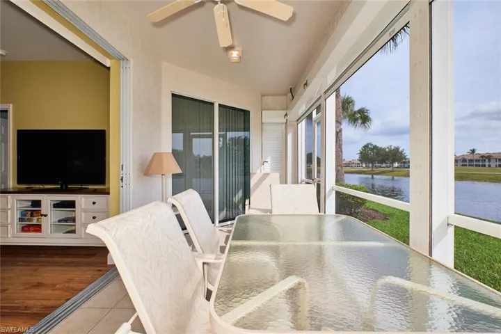 Sunroom / solarium with wood finished floors and a water view