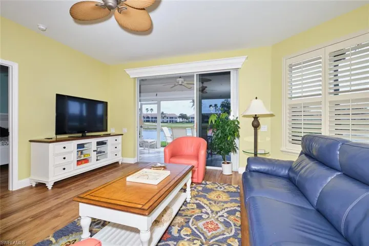 Living area with baseboards, wood finished floors, and ceiling fan