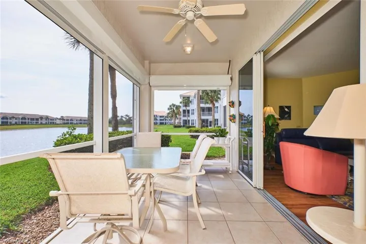 Sunroom / solarium featuring a water view and tile patterned flooring