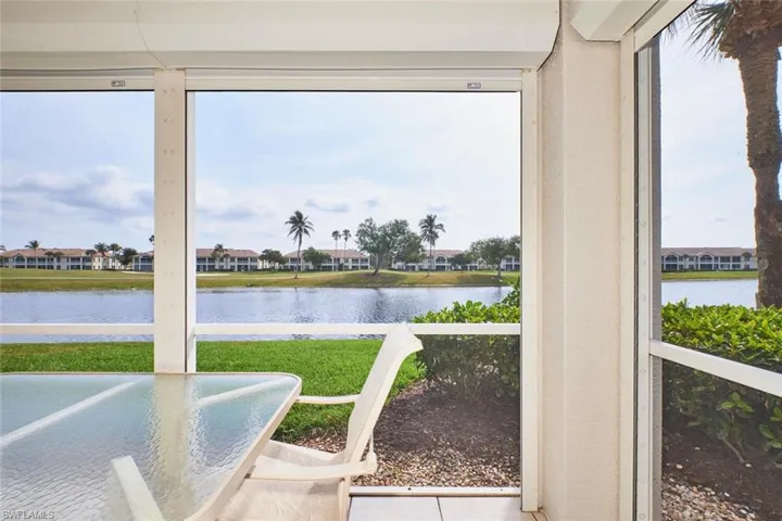 Sunroom / solarium with plenty of natural light and a water view