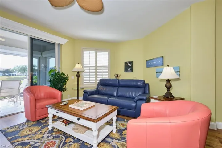 Living area with baseboards and wood finished floors
