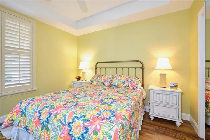 Bedroom featuring a ceiling fan, baseboards, and wood finished floors