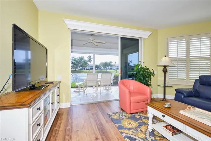Living area with a ceiling fan, baseboards, and wood finished floors