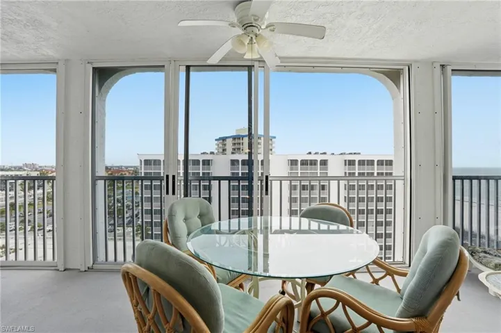 Balcony overlooks beach and pool
