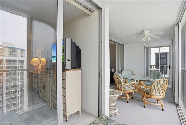 Balcony overlooks beach and pool