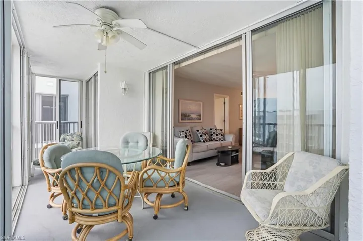 Balcony overlooks beach and pool
