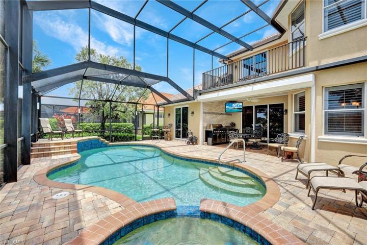 View over Spa with covered tiled lanai outdoor kitchen with gas grill and more