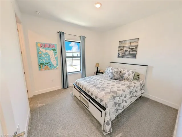 Bedroom with light colored carpet and recessed lighting