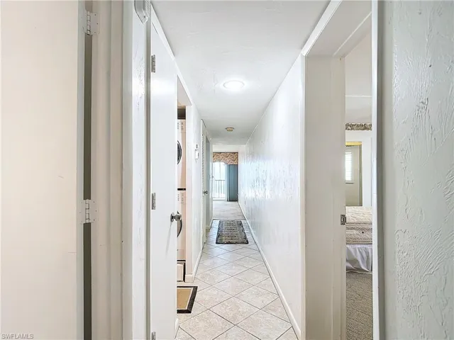 Corridor with light tile patterned floors