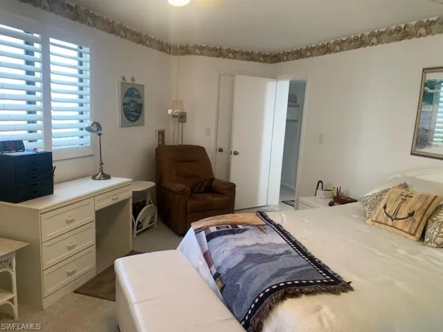 Bedroom featuring light carpet