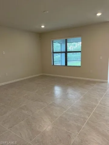 Spare room with baseboards and recessed lighting