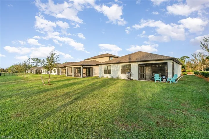 Back of house featuring a yard
